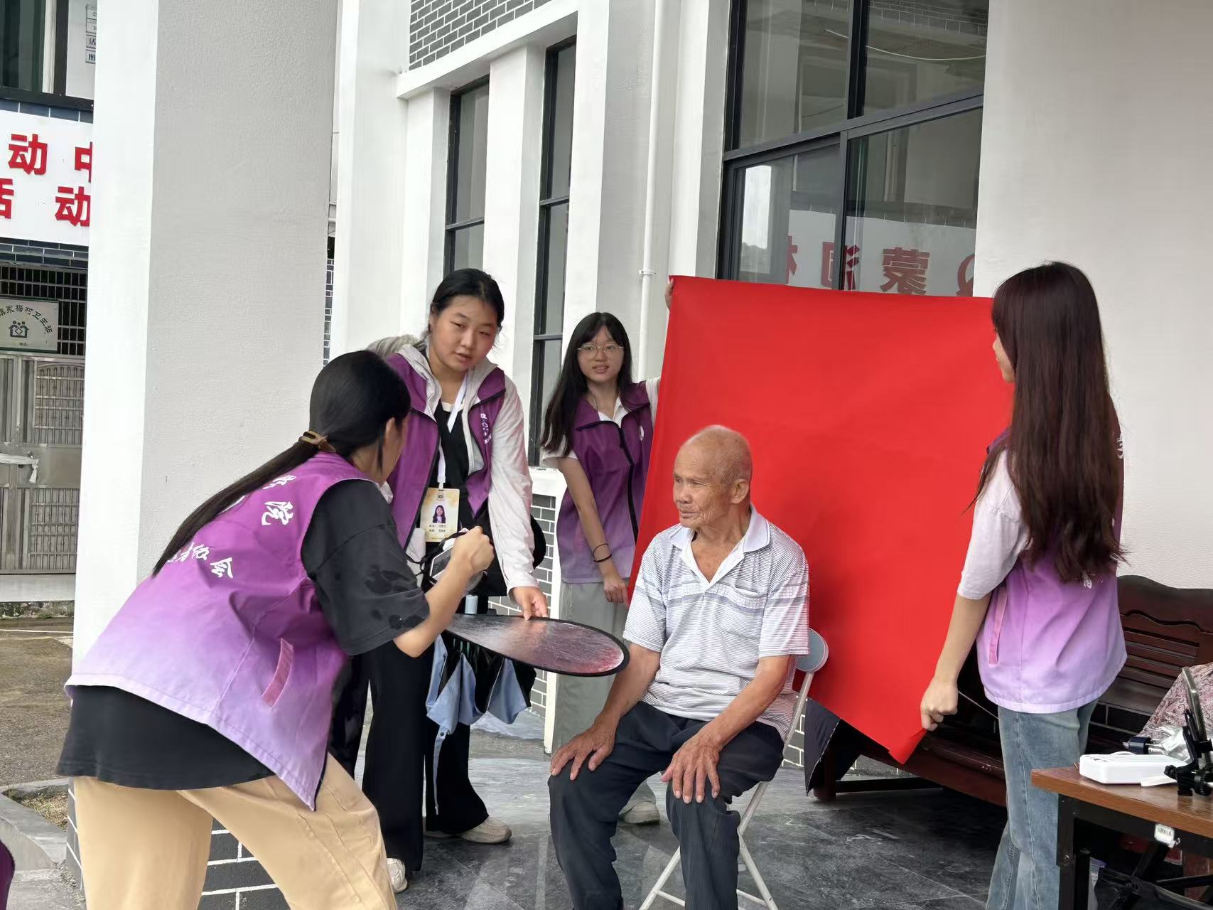 图为暖阳青年为蒙峒古村老人免费拍摄红底证件照 暖阳筑梦突击队 拱图
