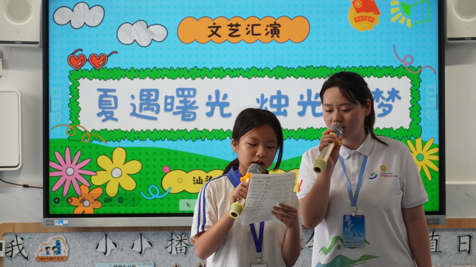 图为文艺汇演现场，志愿者陪伴学生登台展示